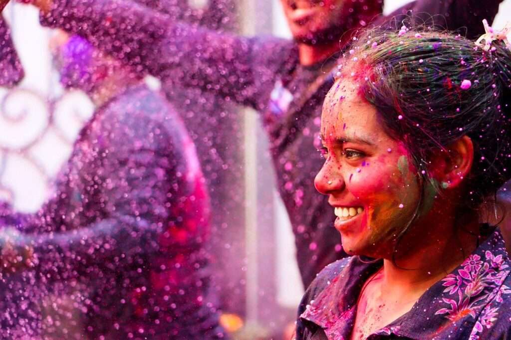 Stock imaage of Indian girl celebrating Holi festival with colours 