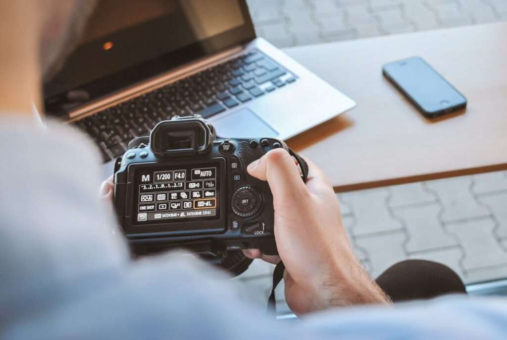 Stock imaage of A person holding a professional camera. 